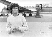 On tour, Micky Dolenz pauses for a moment after departing The Monkees' custom airplane to soak in the band's incredible success during the Summer of Love, 1967